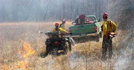 Rex Kelley, Yvonne Ledford & Jack Crowe doing a controlled burn at Doc Rogers Filelds in Coker Creek.